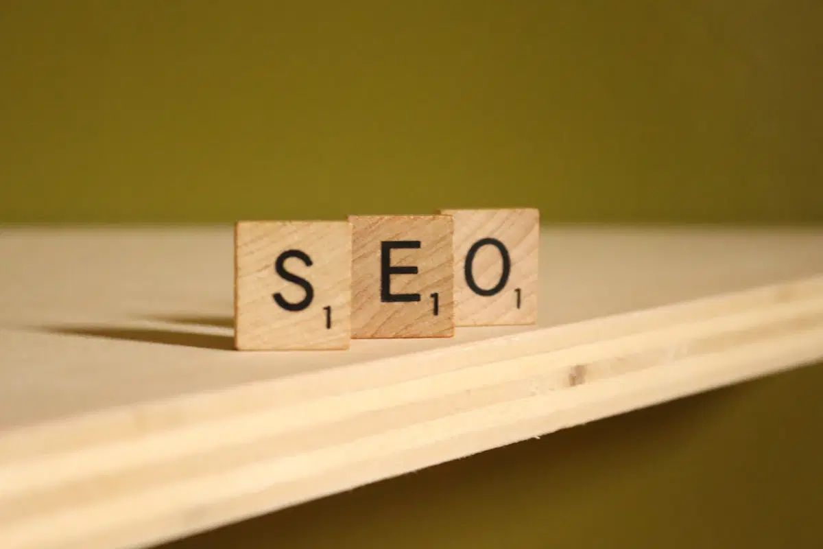 Wooden letter tiles on a table spelling out SEO