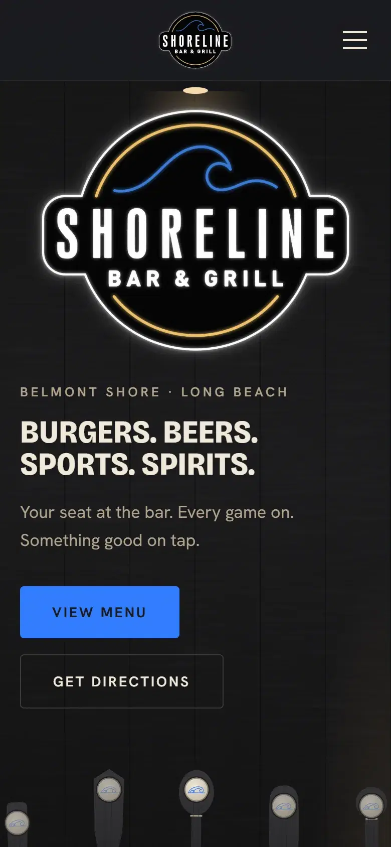 The Shoreline Bar & Grill homepage on a phone, with the neon sign and the View Menu button