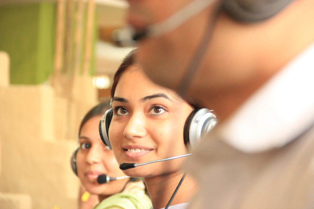 Sales team members wearing headsets taking calls from qualified leads