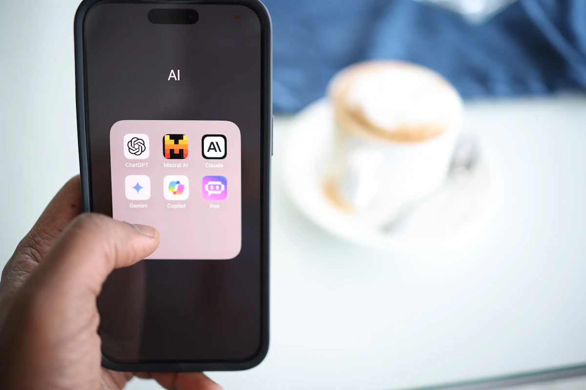 Phone showing a folder of AI assistant apps including ChatGPT