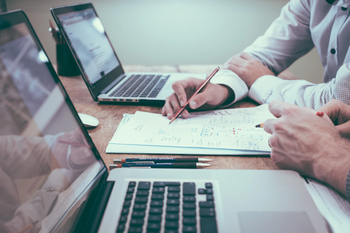 Marketing team optimizing landing pages and conversion funnels on laptops